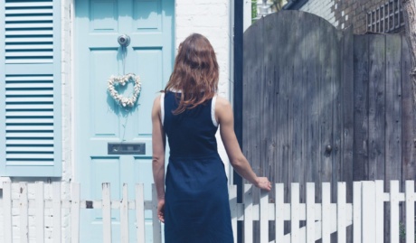 Young Woman Looking At House