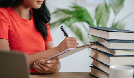 Woman Holding Checklist In Office