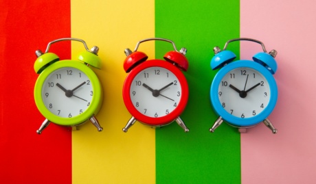 Colorful Alarm Clock On Colorful Background.